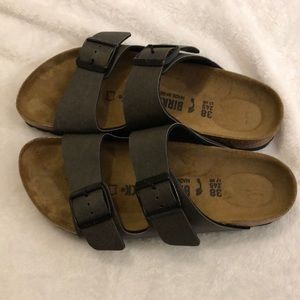 Birkenstocks. Hard to tell color but I believe they are dark brown. Size 38